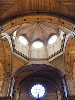 Interior view of dome showing artisanal woodwork and soft ambient lighting.