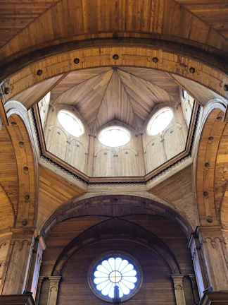 Close-up of wooden beams and geometric patterns in a dome structure.