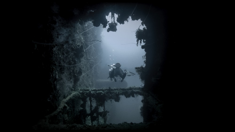 a man riding a horse through a tunnel in the water