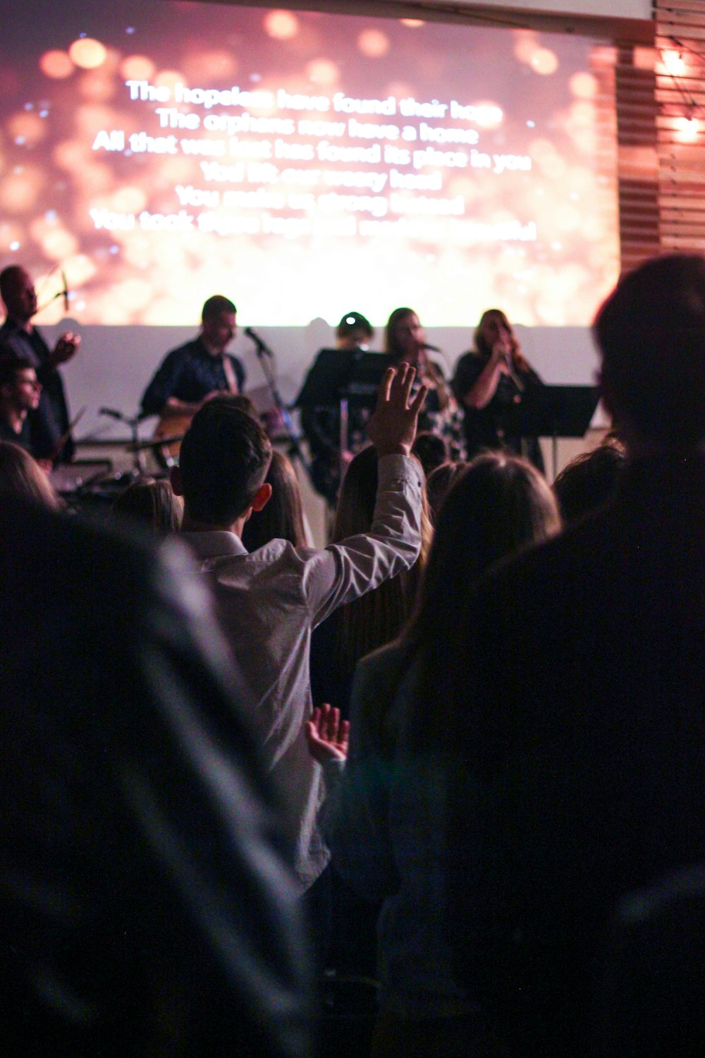 people singing in front of band