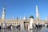 A group of happy pilgrims posing near the Prophet's Mosque in Madinah with bright blue sky.