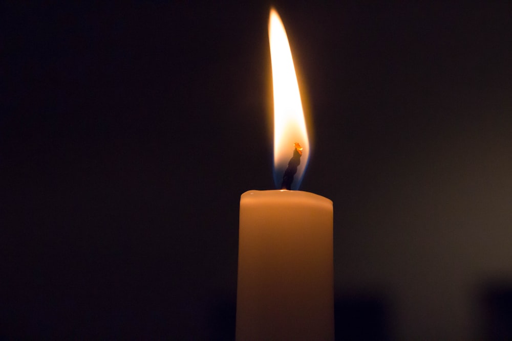 white candle in black background