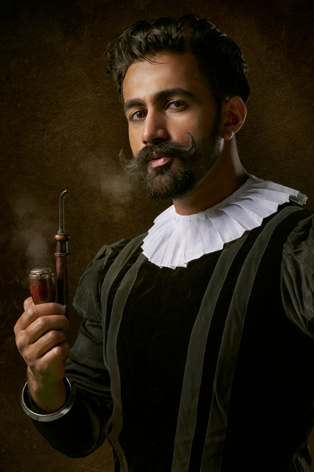 man wearing traditional clothes and holding smoking pipe