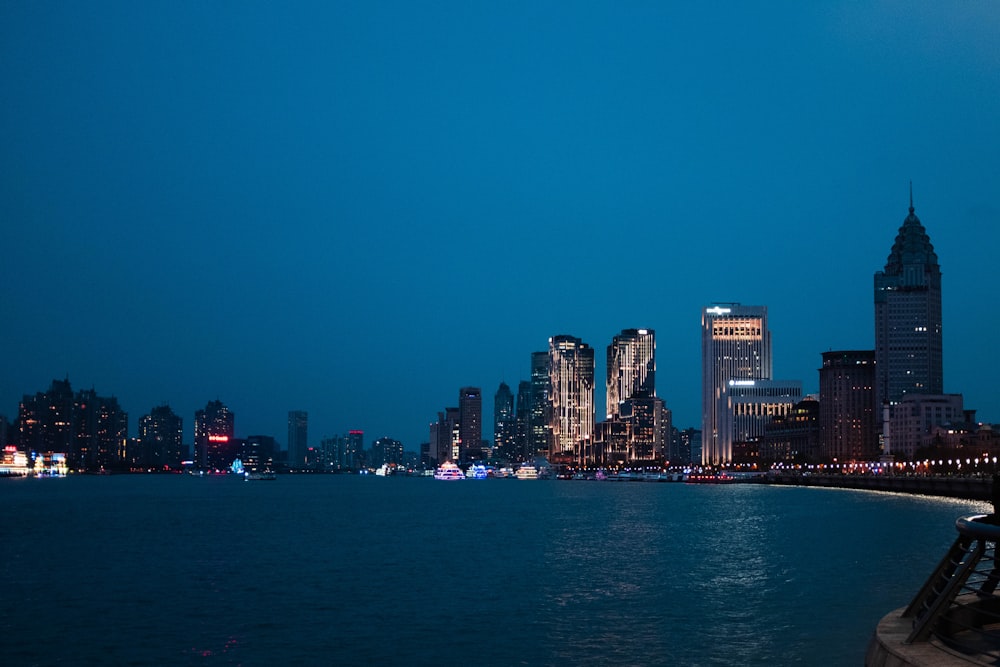 body of water across city buildings during nighttime