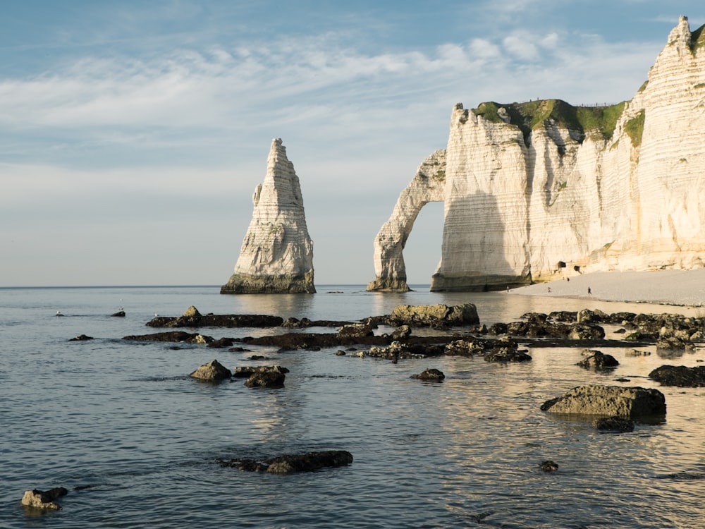 brown rock formation on body of water