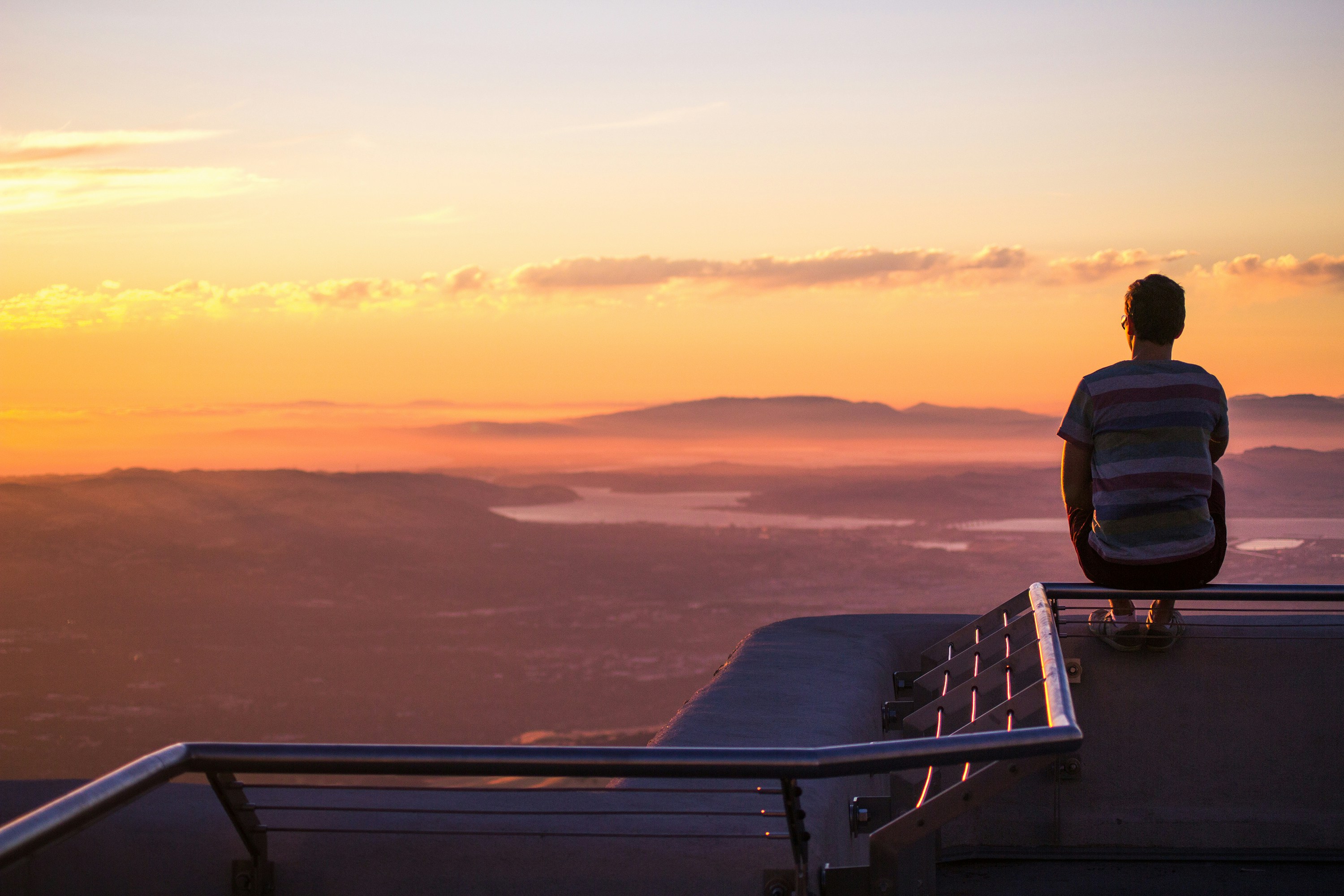 man sitting on railing