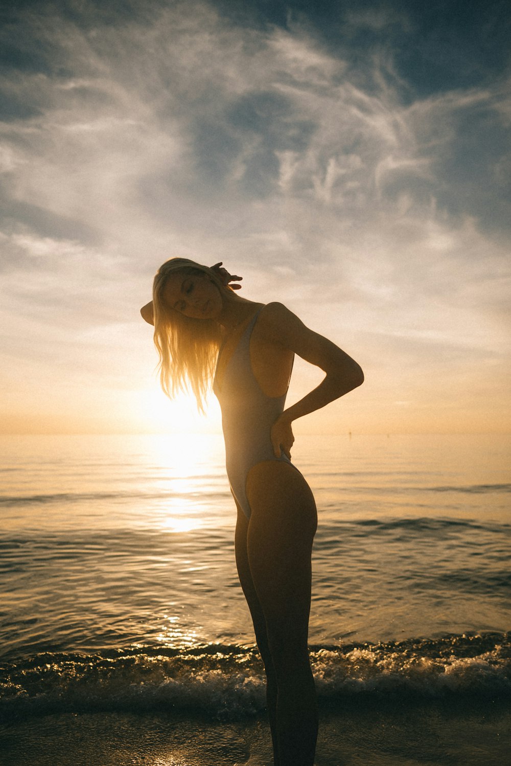 woman wearing bikini standing near ocean