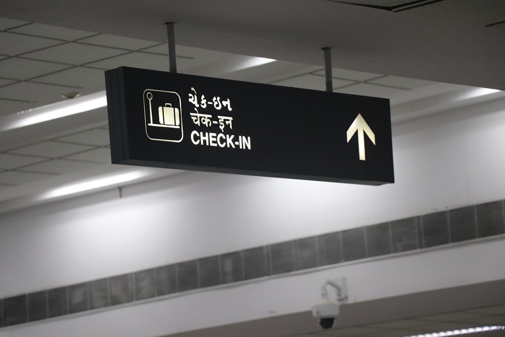 grayscale photography of check-in sign