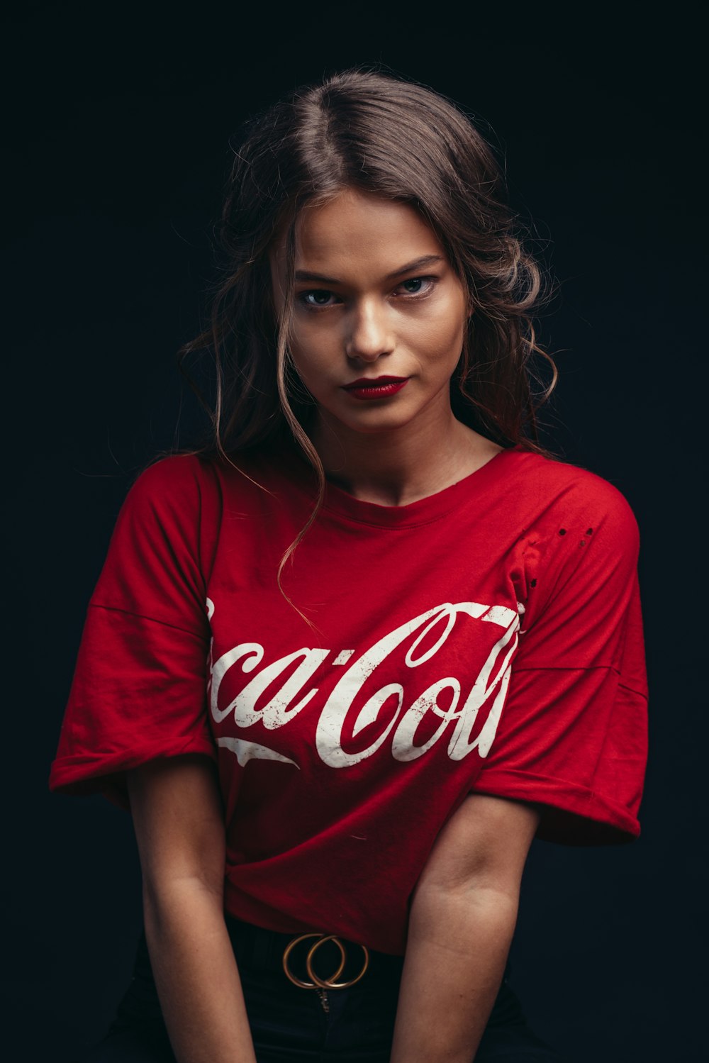 woman in red Coca-Cola crew-neck t-shirt