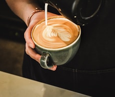 person pouring coffee on cup