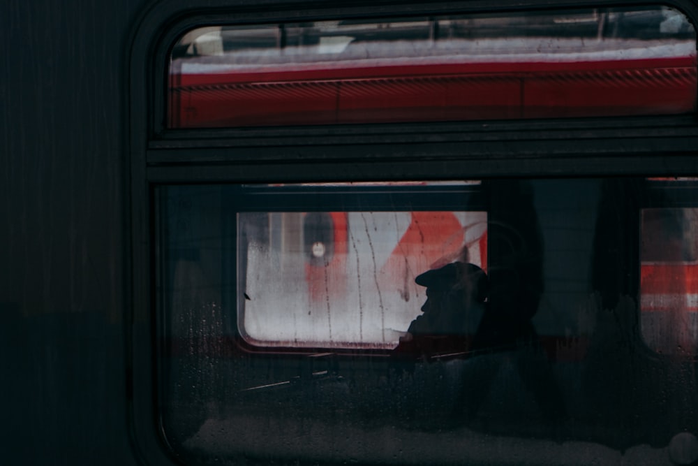 silhouette of man sitting inside train