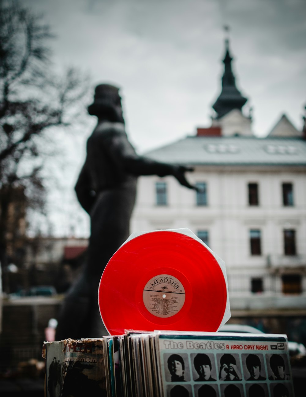 vinyl record on sleeves near statue