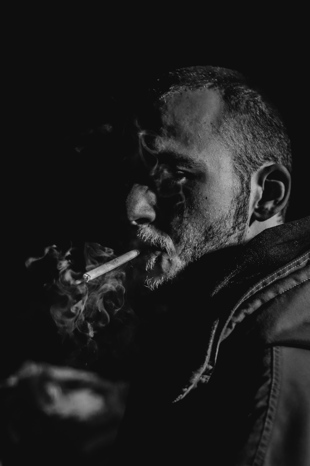 man smoking black and white photography