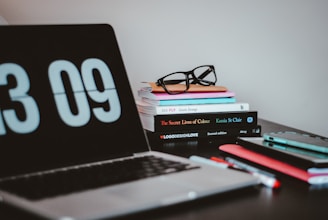silver MacBook Pro near books