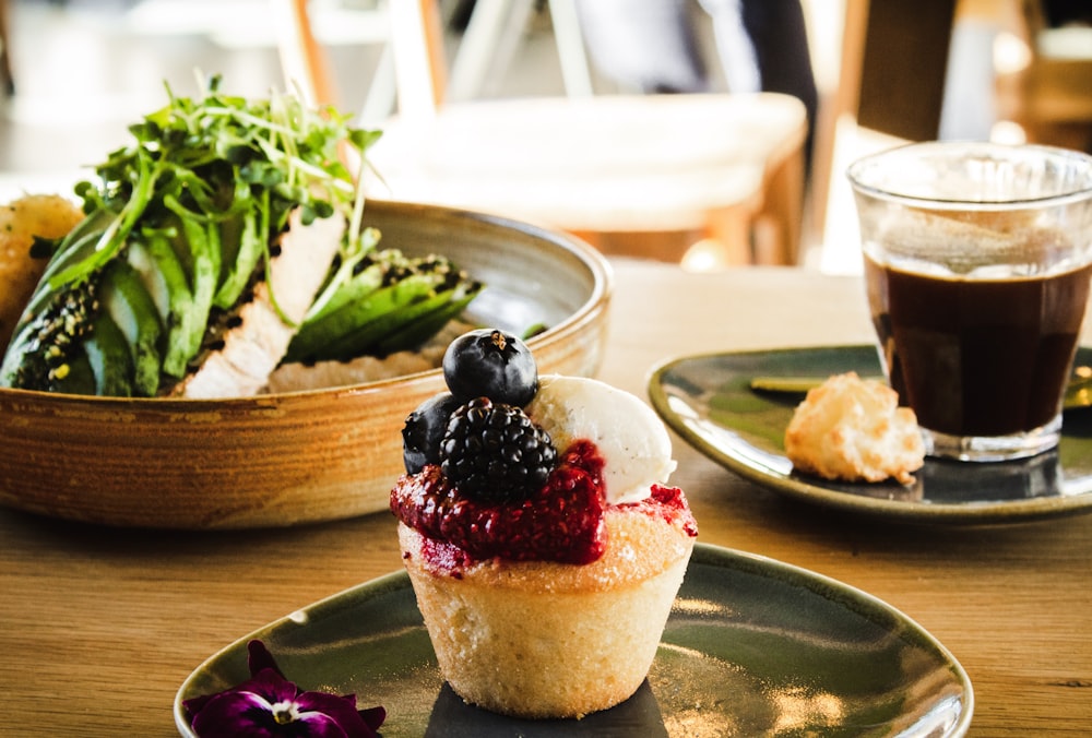 cupcake with berry toppings on plate