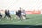 A diverse group of athletes celebrating a victory on a sports field.