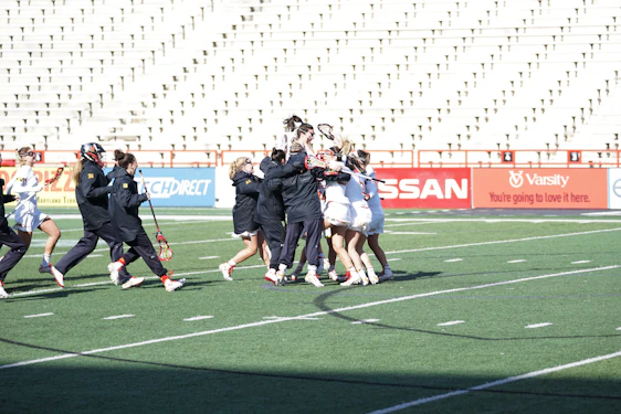 A dynamic sports team celebrating a victory together on the field.
