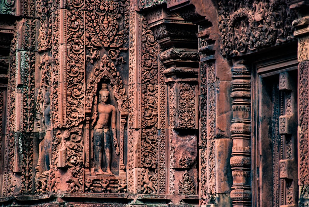 male statue on brown concrete building