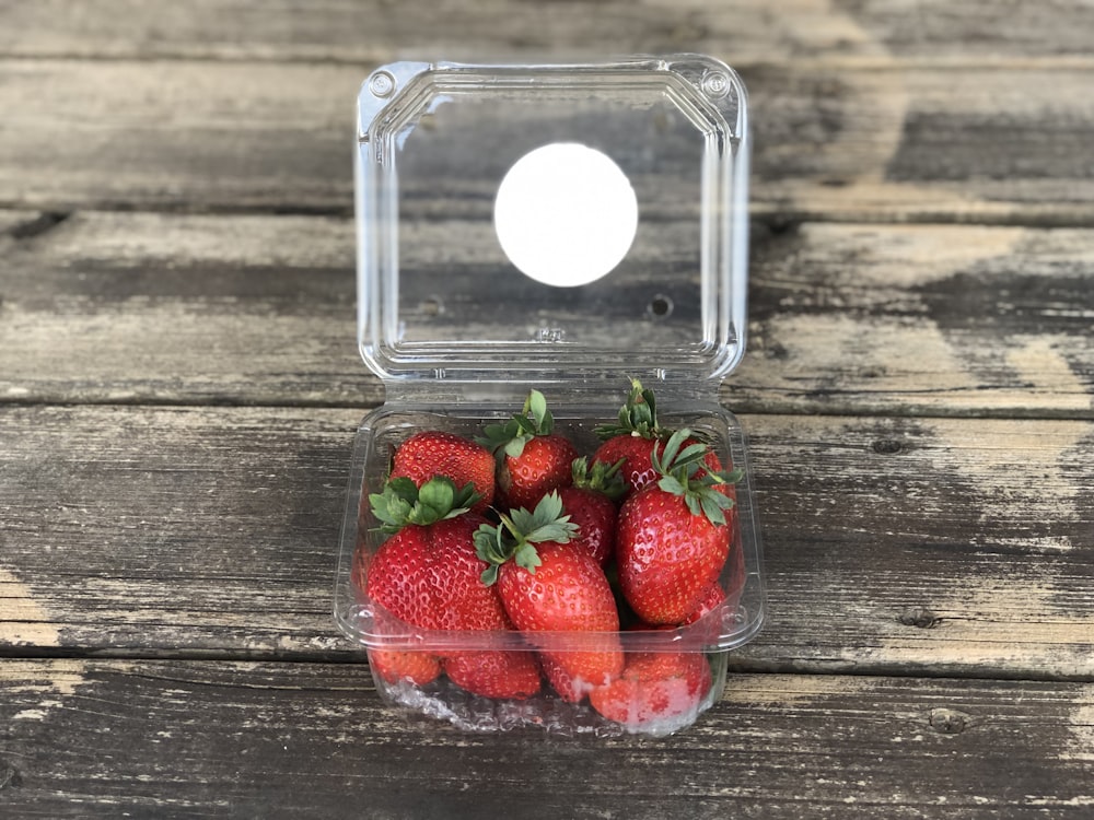 pack of strawberries on brown wooden surface