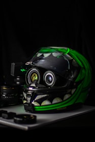 black and green full-face helmet on white wooden table