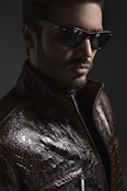 man wearing black leather jacket and sunglasses