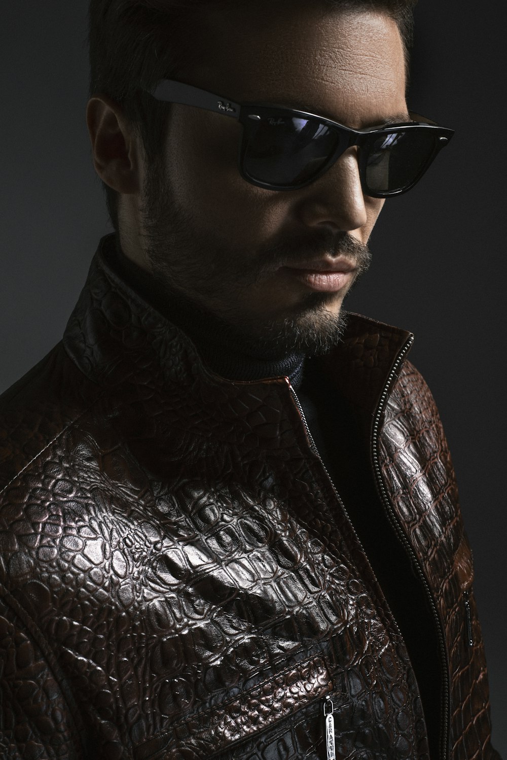 man wearing black leather jacket and sunglasses