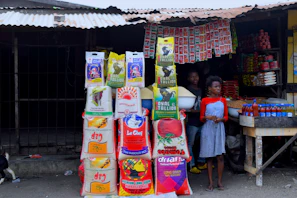 A vibrant market stall displaying bags of fragrant basmati and non-basmati rice varieties.