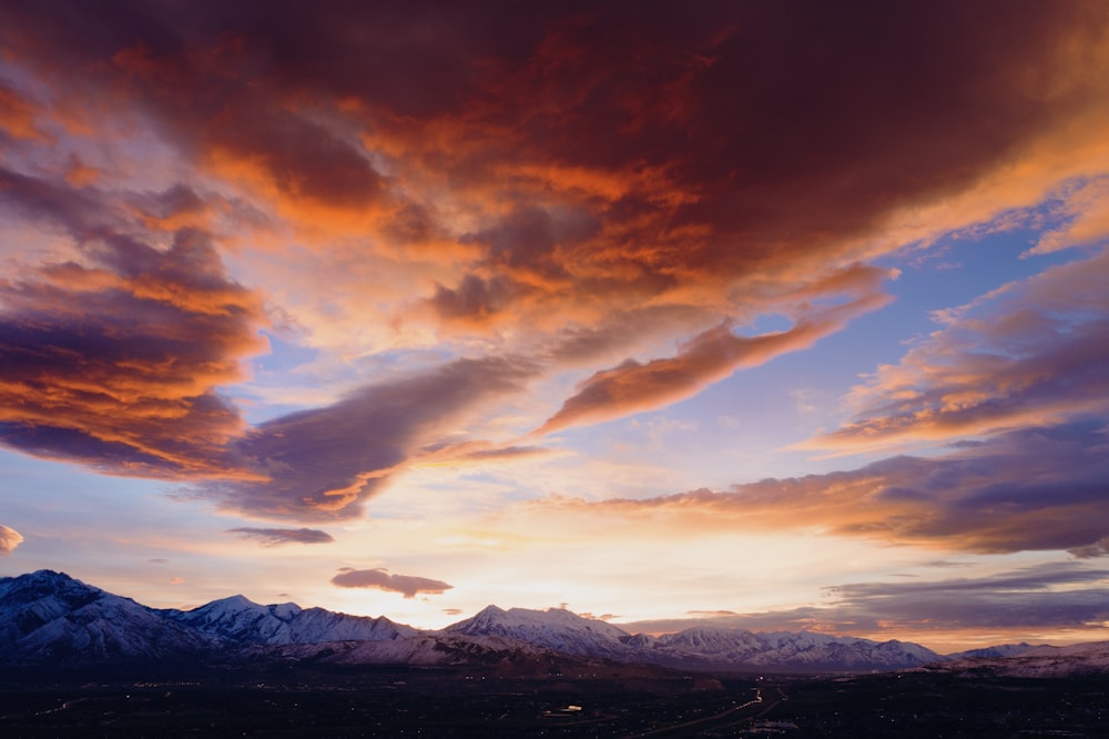 rocky mountain under cloudy sky during golden hour