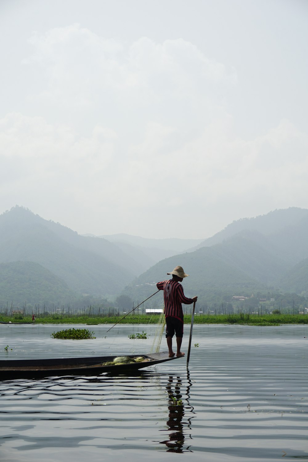 a man standing on a boat in the water