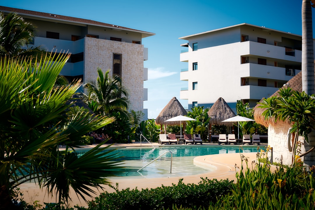 two gray parasol set near swimming pool,