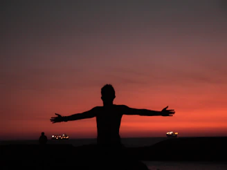 silhouette of man spreading both arms