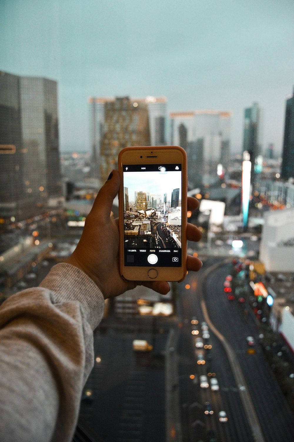 person taking picture at city buildings