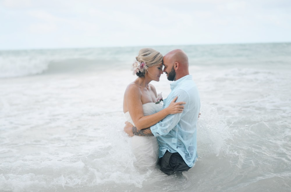 man and woman standing and almost kissing on body of water