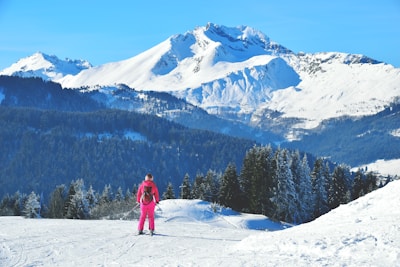 Close-up of a soft, moisture-wicking ski base layer in a vibrant color on a snowy mountain backdrop.