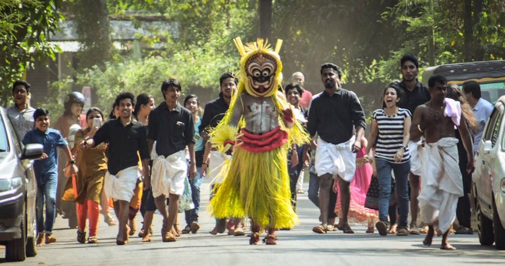 group of people parade on the road during daytime