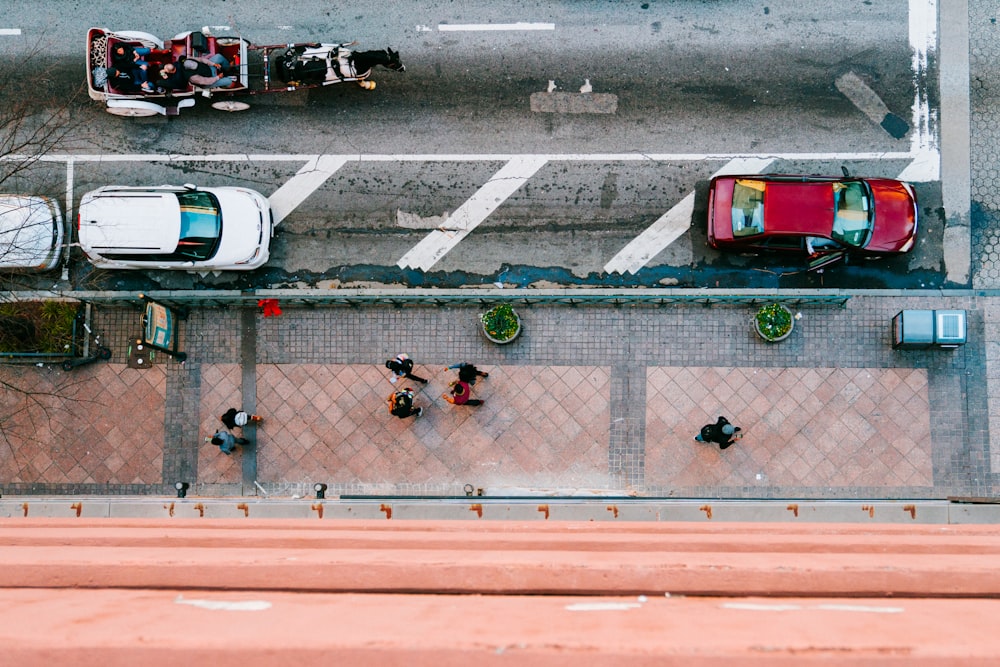 three vehicle parked beside building top-view photography