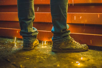 man wearing brown high-top sneakers