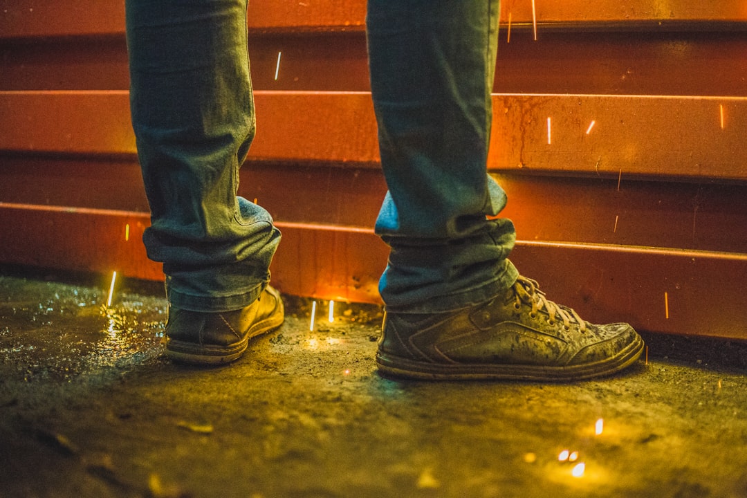 man wearing brown high-top sneakers