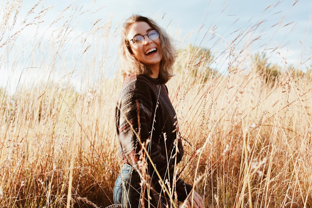 woman in black sweatshirt standing on grass field