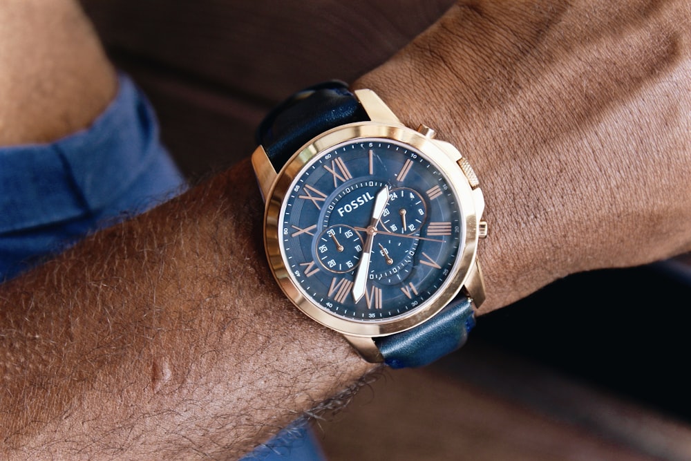 round gold-colored Fossil chronograph watch with leather band displaying 1:37 time