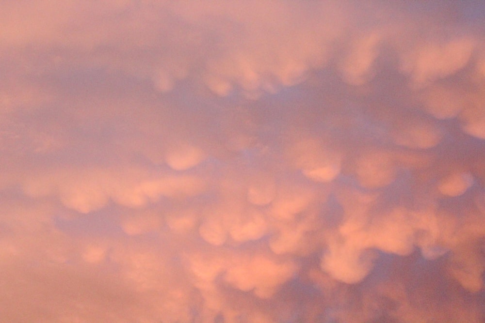 a plane flying in the sky with a lot of clouds