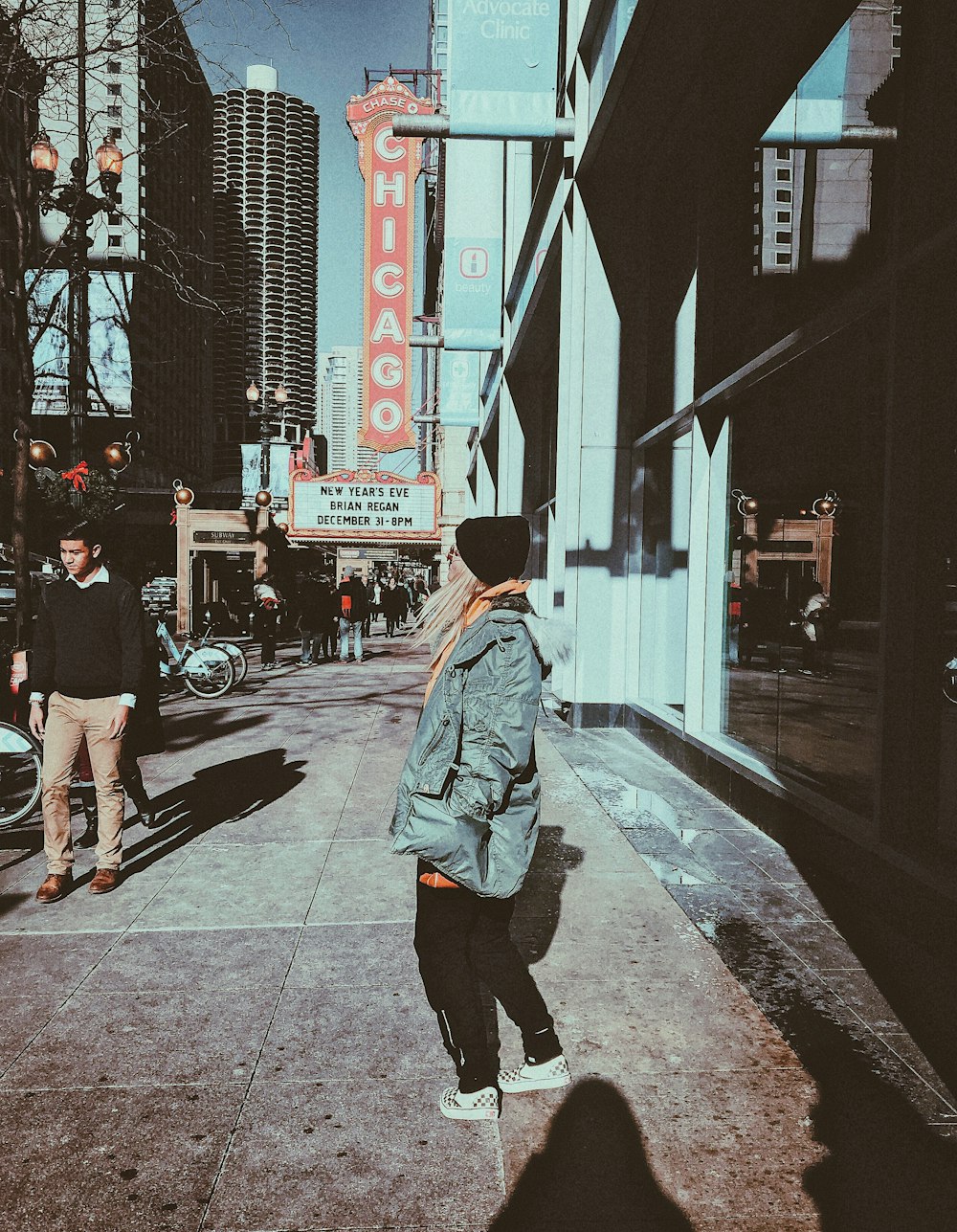 woman walking on pathway near buildings