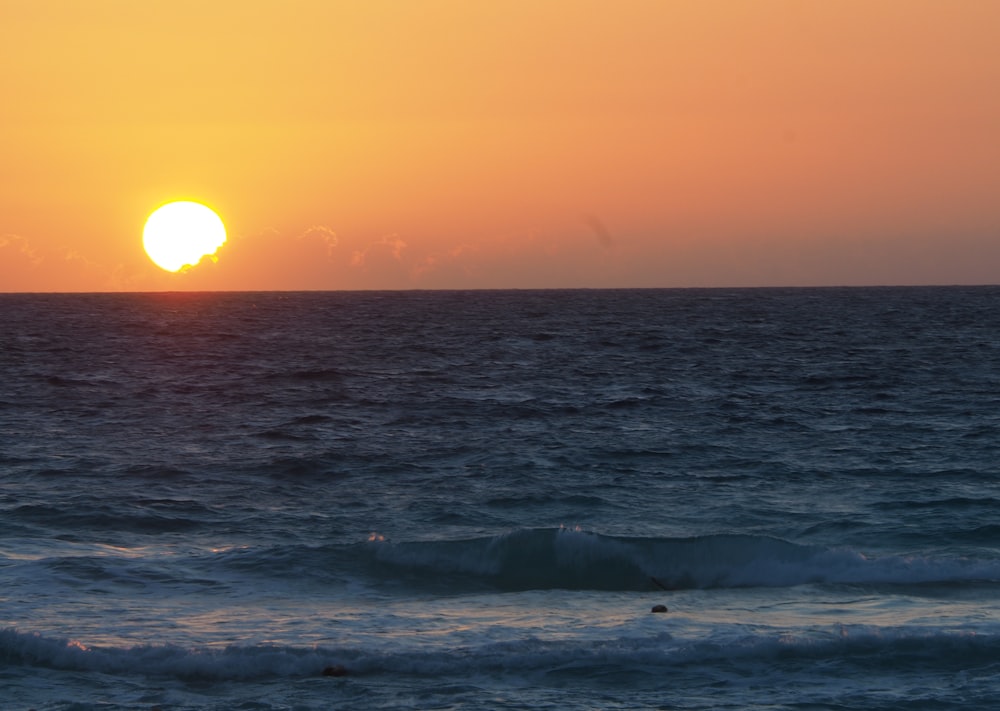 body of water during sunrise