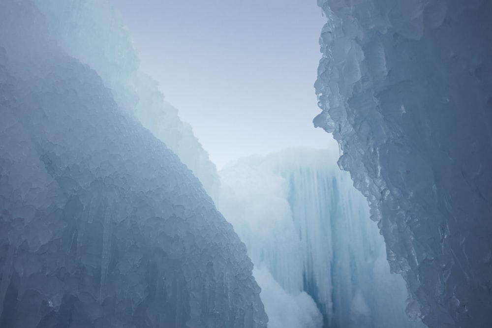 a frozen waterfall with ice hanging off of it's sides
