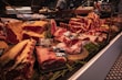 Display of various fresh meat cuts in market