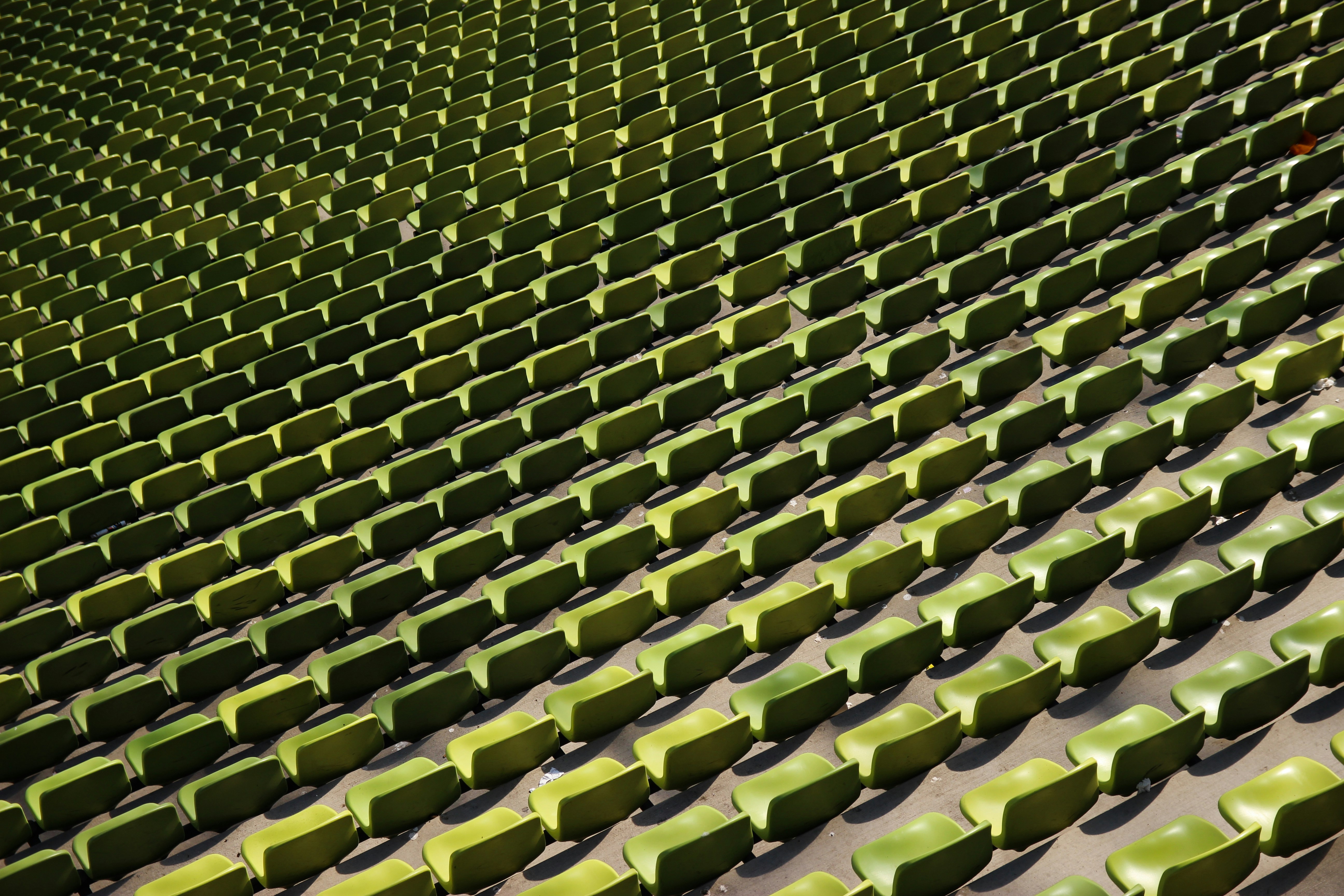 a row of green seats sitting next to each other, 