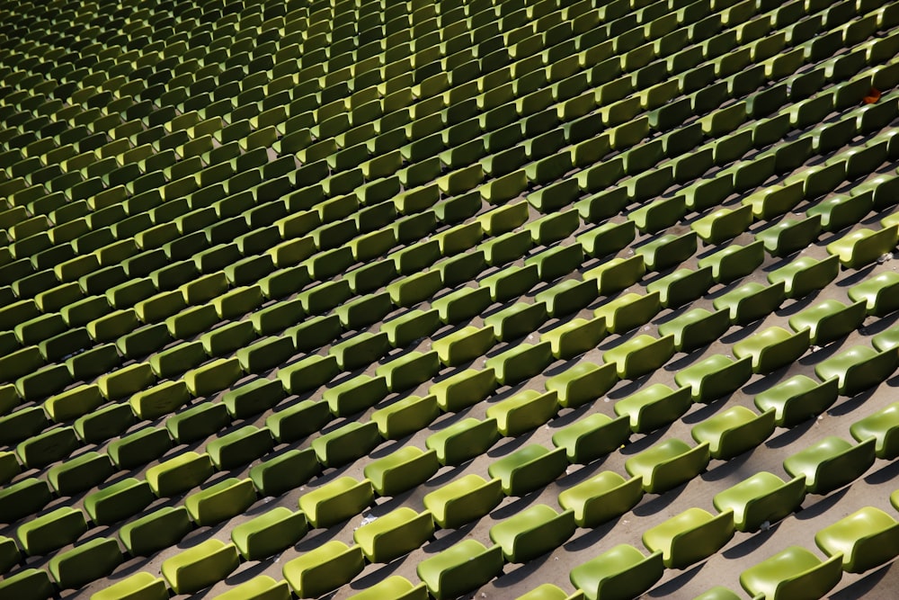 a row of green seats sitting next to each other