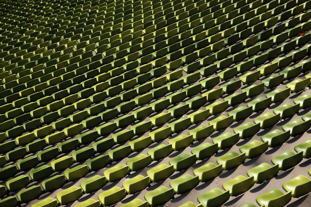 a row of green seats sitting next to each other,