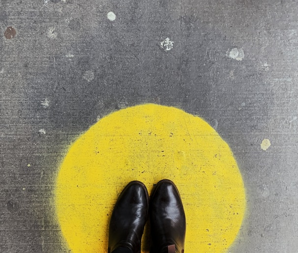 person standing on round yellow painted surface
