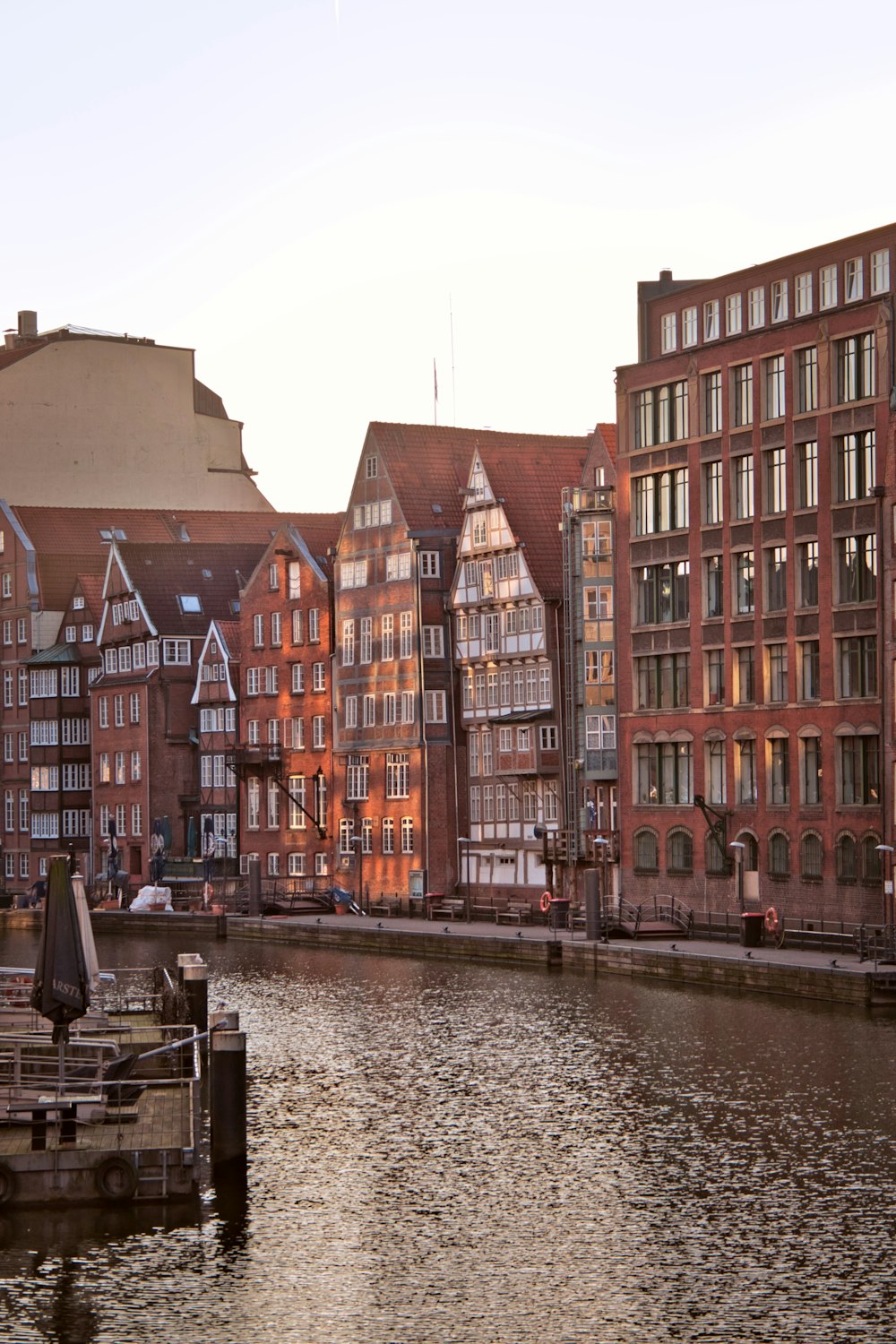 red concrete buildings near body of water during daytime